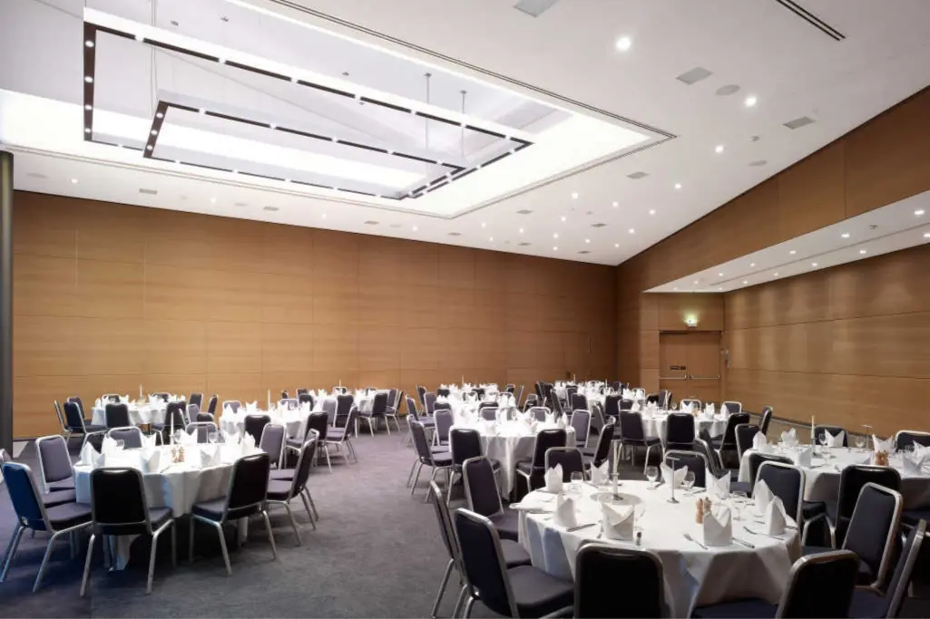 Seminarraum mit runden Tischen und StoSilent Distance-Akustikdecke.